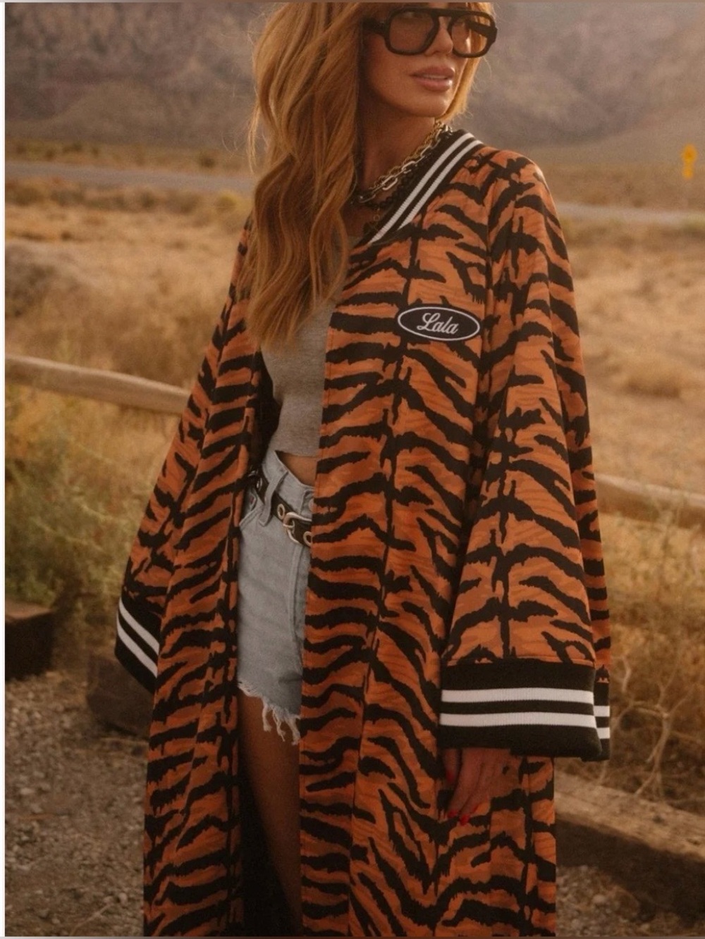 Dressed in LALA Orange and Black Tiger-Print Coat